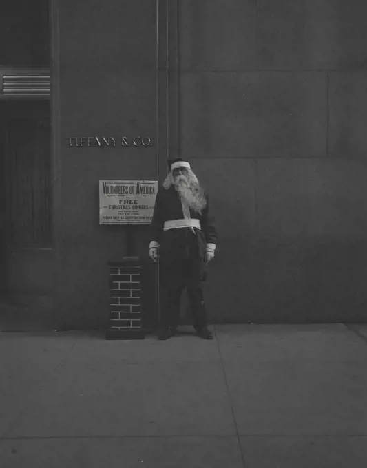 Vintage photograph. man in Santa suit in front of tiffany and co jewelry store