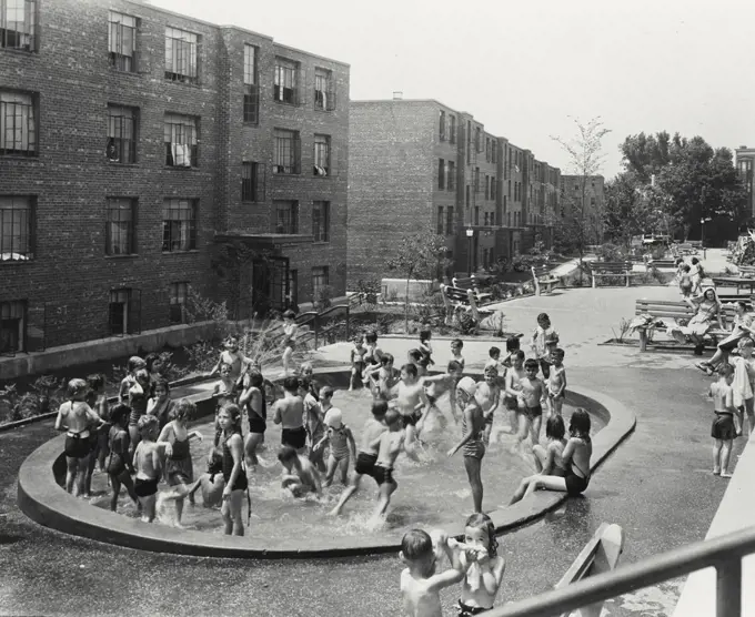 Vintage photograph. Children playing in swimming pool at Mulford Gardens Public Housing, completed August 1941 in Yonkers, New York