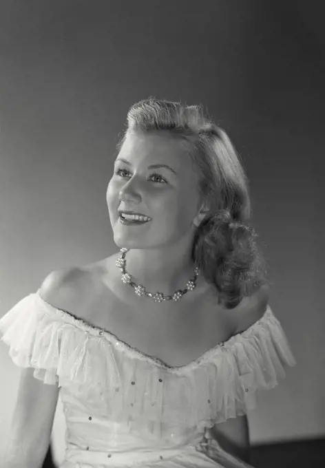 Vintage photograph. Woman in dress smiling at camera.