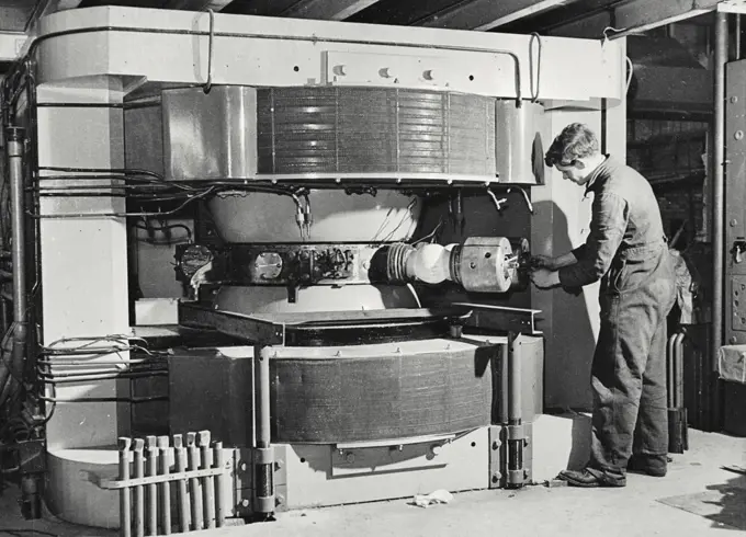 Vintage photograph. The magnet and accelerating chamber of the cyclotron. In this photograph the dee-adjusting mechanism is being assembled at the Cavendish Laboratory, Cambridge, University, England