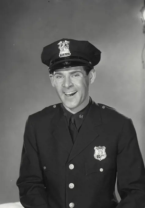 Vintage photograph. Man in police uniform smiling