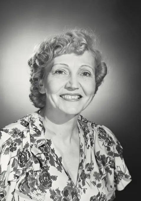 Vintage photograph. Older woman wearing floral blouse smiling