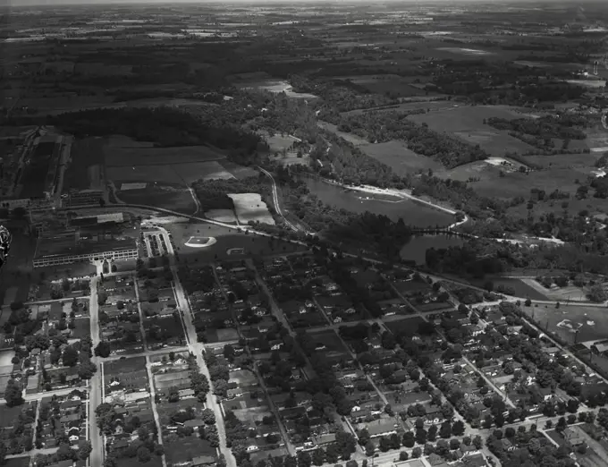 Aerial view of Richmond, Indiana. On the left is the Crosley Corporation, refrigerators. Also left, the Belden Corporation with its own ball park. On the right is an artificial lake with swimming and fishing, Wayne County Conservation Club. State Highway 38 running through middle