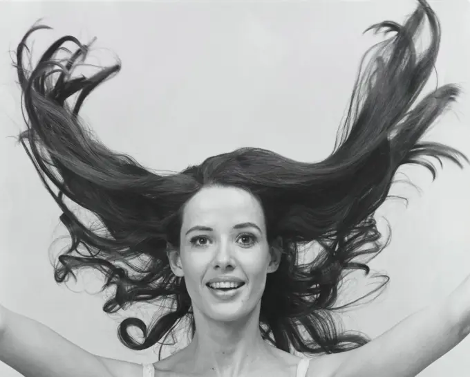 Portrait of a young woman with her hair flying