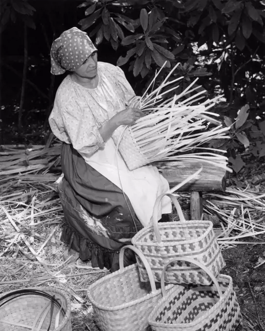 Cherokee woman weaving a basket