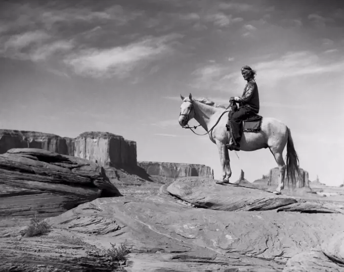 Navajo man riding a horse
