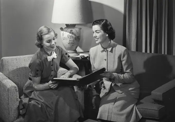 Two businesswomen holding a file