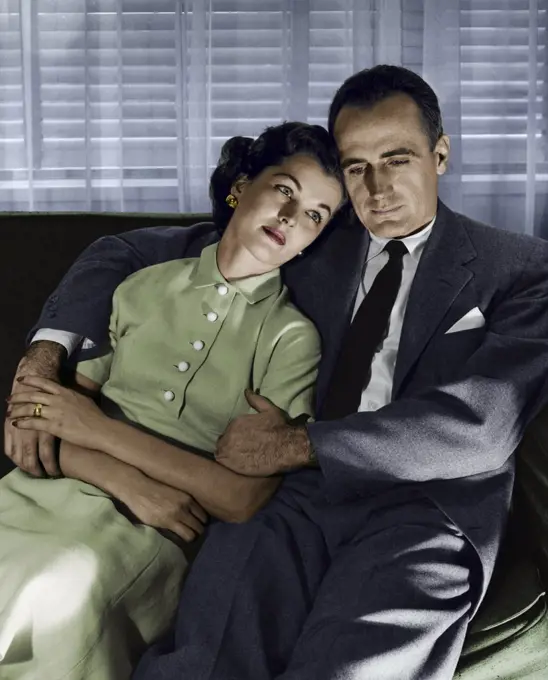 Close-up of mid adult couple sitting on couch
