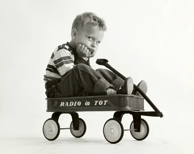 Portrait of a boy sitting in a wagon