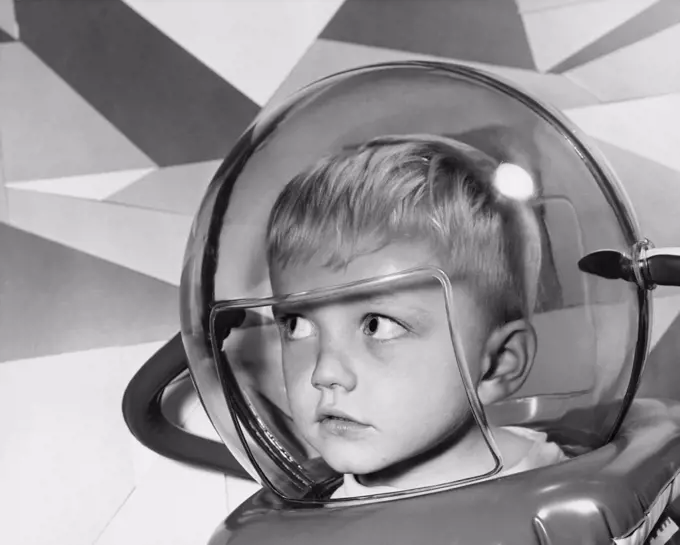 Close-up of a boy wearing a space helmet