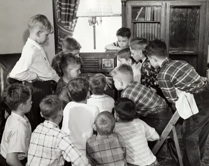 Group of boys listening to the radio