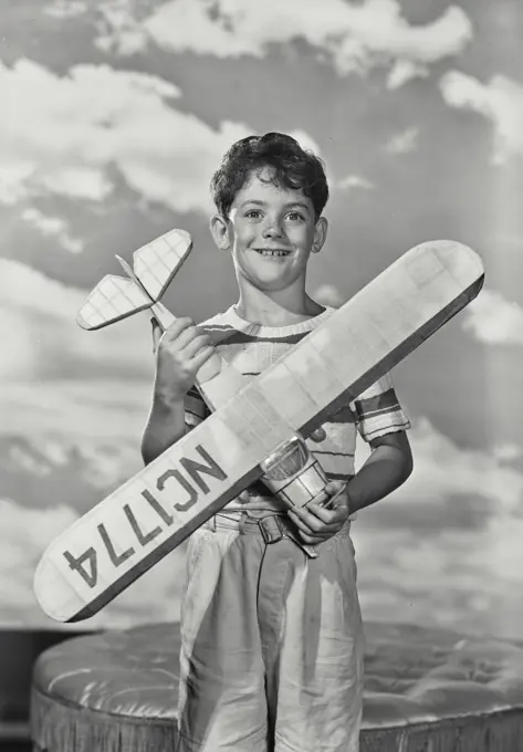 Boy holding a model airplane