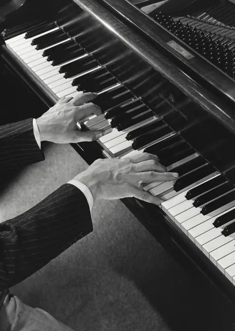 High angle view of a person's hands playing the piano