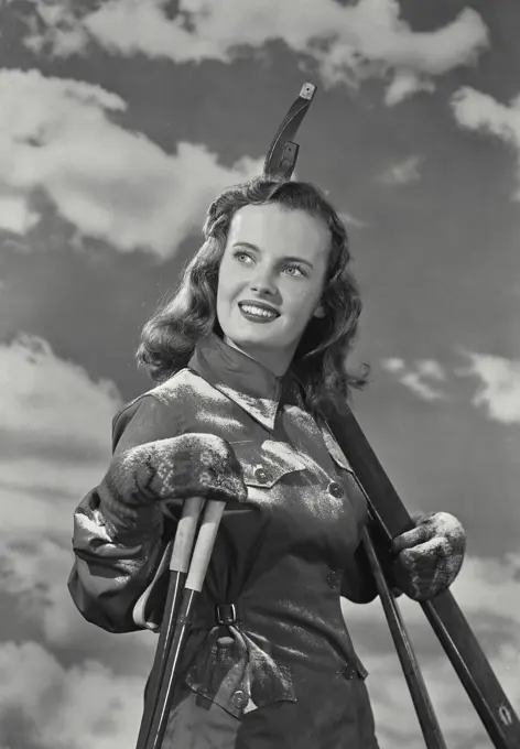 Side profile of a young woman holding a ski