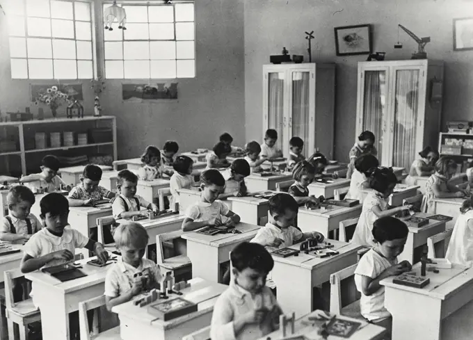 Vintage photograph. Group of school children in an arts and crafts class for white children in the Congo