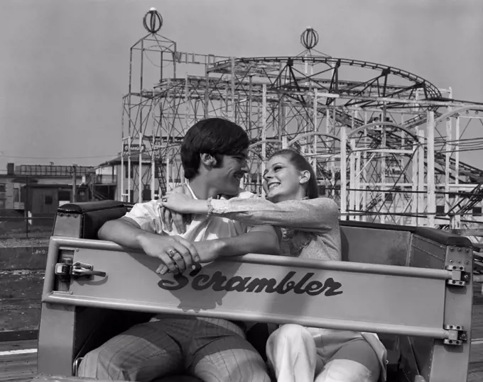Young couple in amusement park