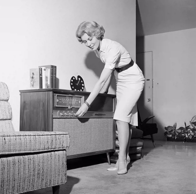 Woman listening to radio in living room