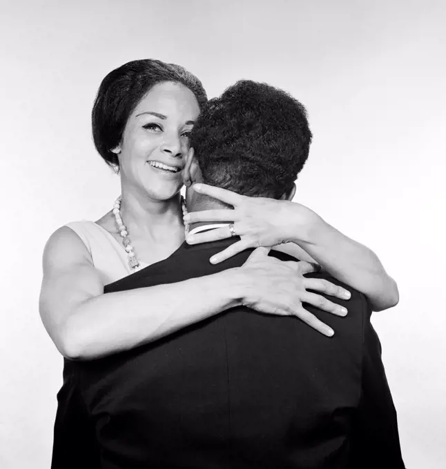 Embracing African-american married couple, studio shot