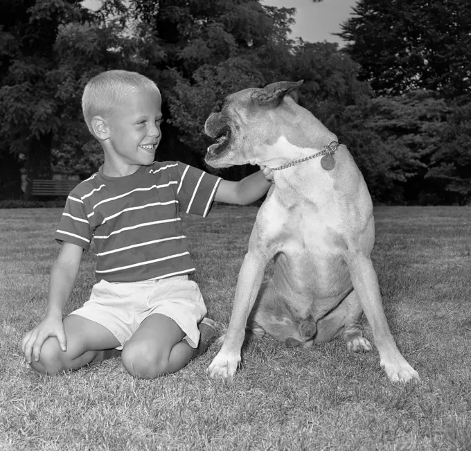 Portrait of boy with boxer dog
