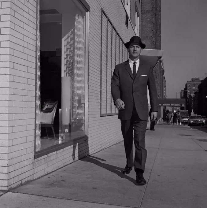 Man in suit walking down street