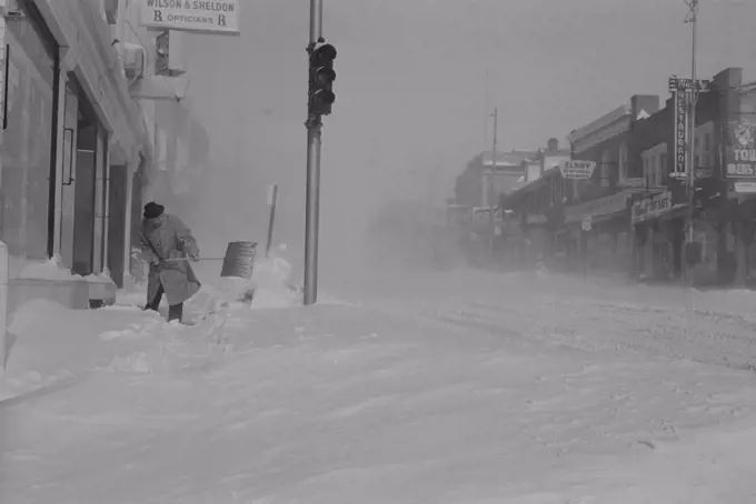 USA, Pennsylvania, Man digging snow from street