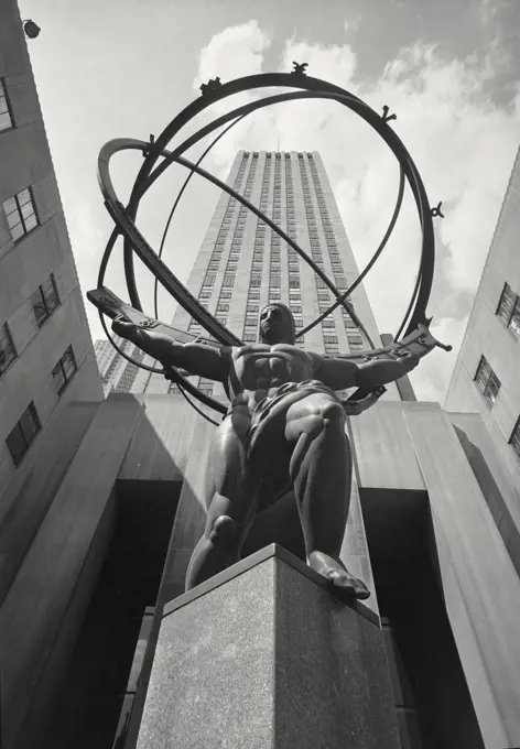 Vintage photograph. Low angle view of Atlas Statue in front of the International Building in Rockefeller Center, Manhattan, New York City, New York, USA