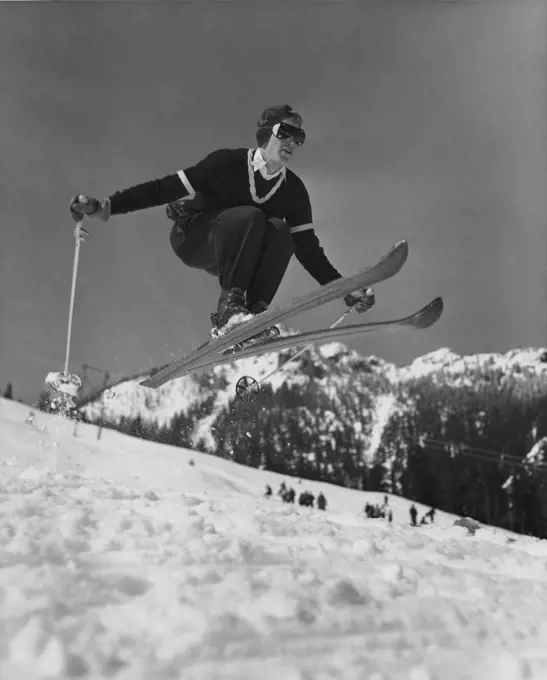 Low angle view of young man skiing downhill