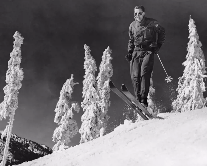 Low angle view of a mid adult man skiing on snow