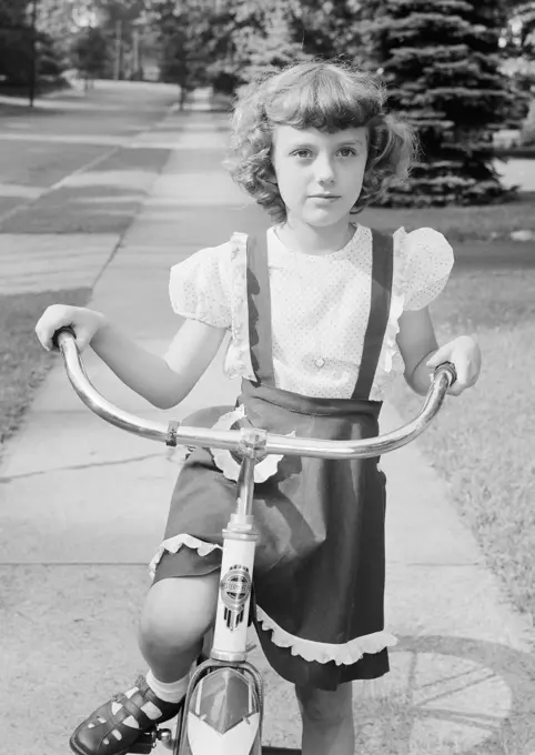 Girl with bicycle in park