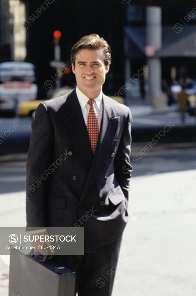 Stock Photo: 280-434A Businessman holding a briefcase and smiling