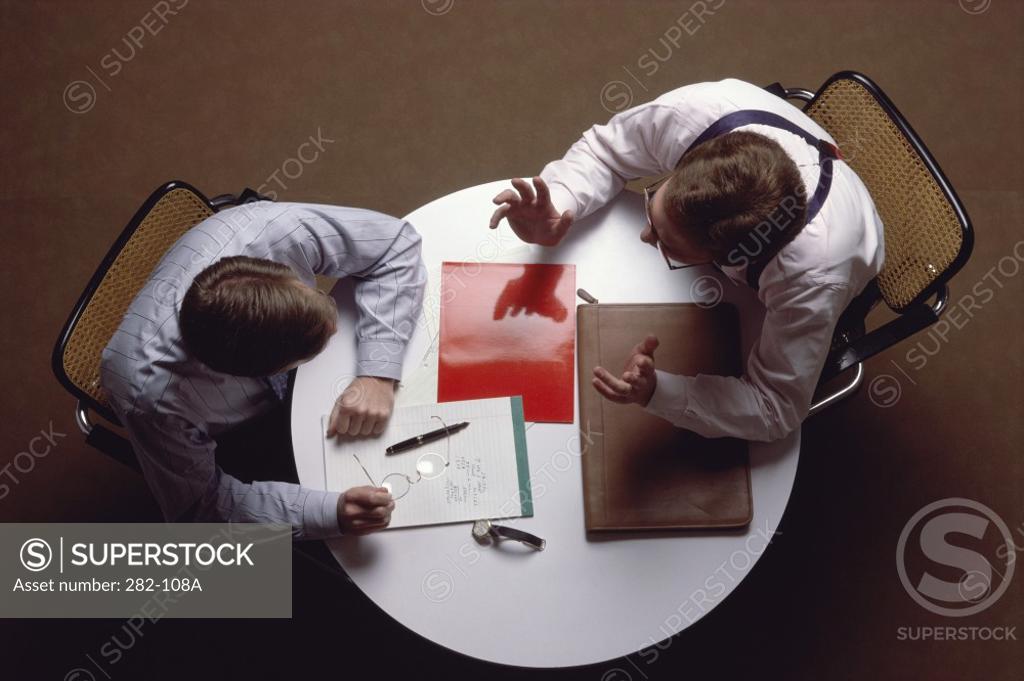 Stock Photo: 282-108A High angle view of two businessmen talking at a table
