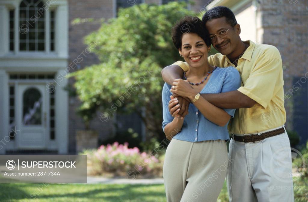 Stock Photo: 287-734A Mature man with his arms around a mature woman and smiling