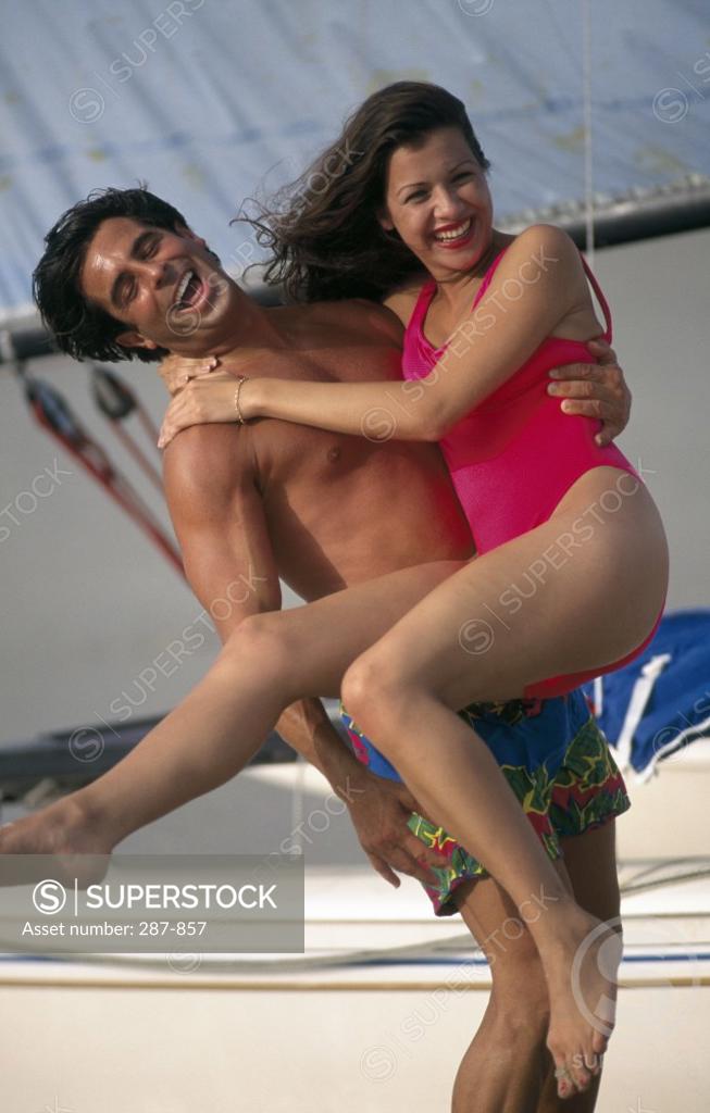 Stock Photo: 287-857 Young man carrying a young woman