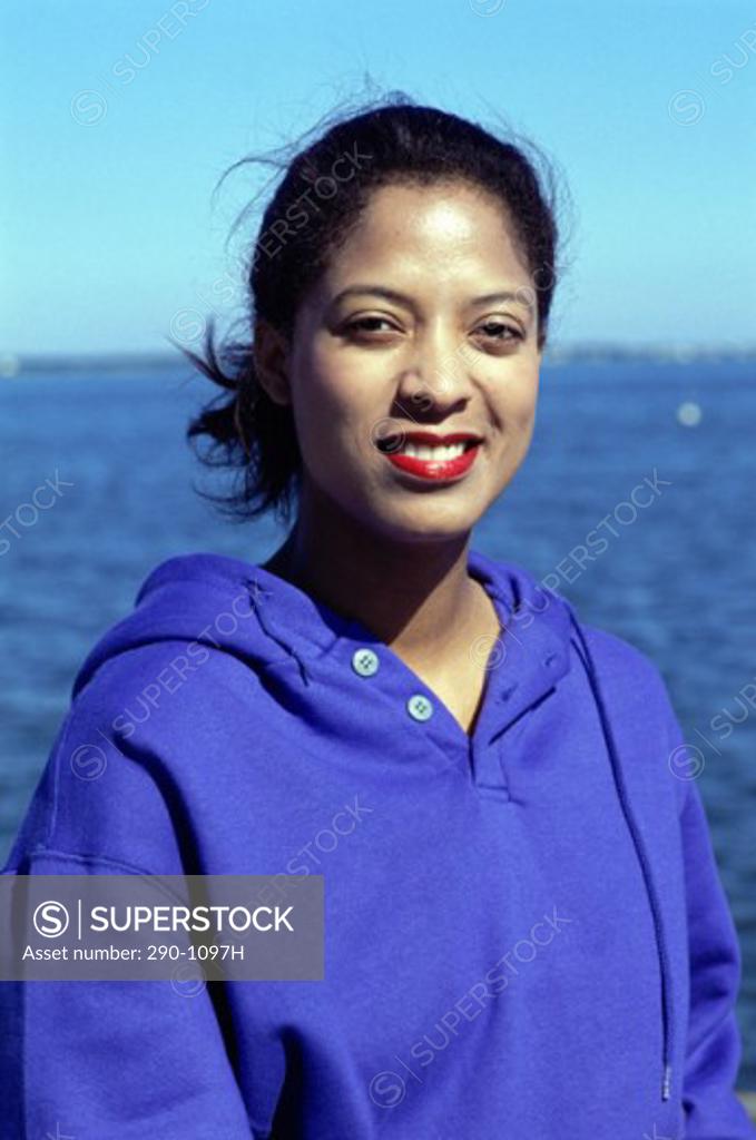 Stock Photo: 290-1097H Portrait of a young woman smiling on the beach
