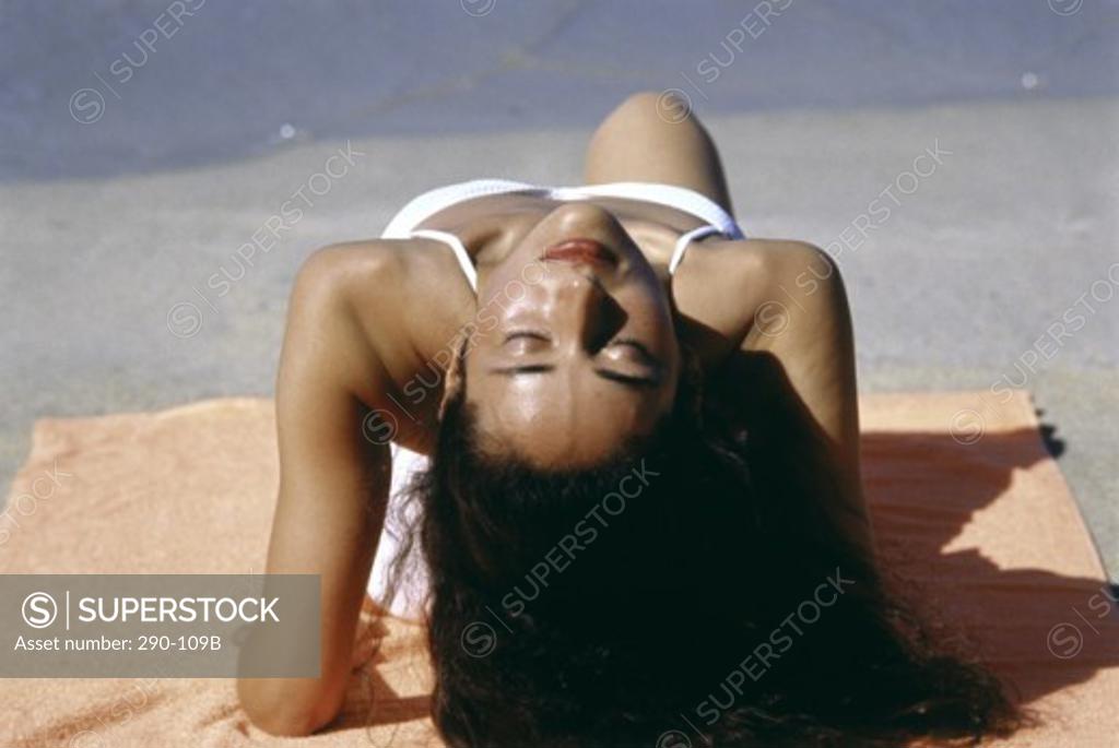 Stock Photo: 290-109B Young woman sunbathing on the beach