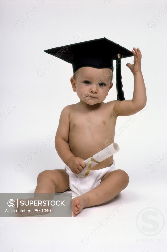 Stock Photo: 290-1340 Baby wearing a mortar board and holding a diploma
