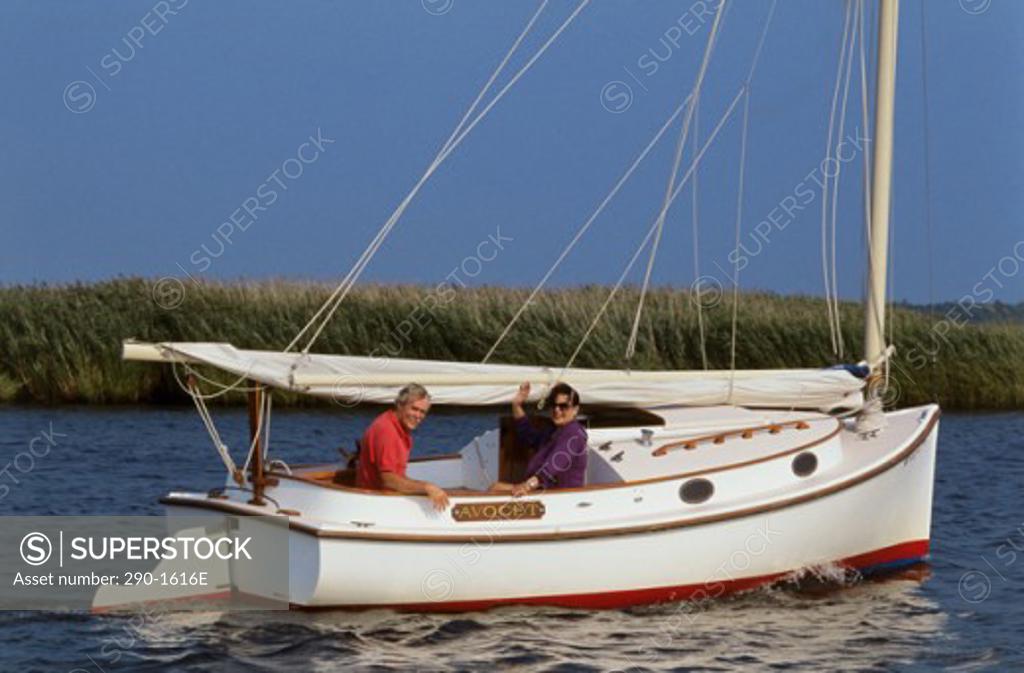 Stock Photo: 290-1616E Mature couple sitting on a sailboat