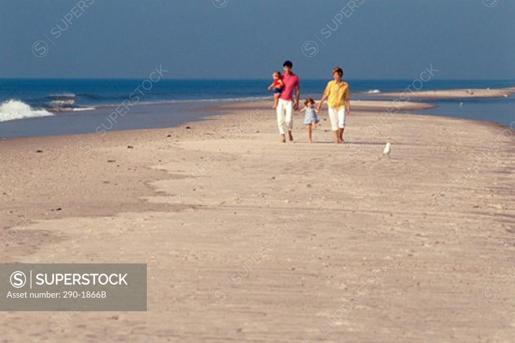 Stock Photo: 290-1866B Man and woman with their son and daughter strolling on the beach
