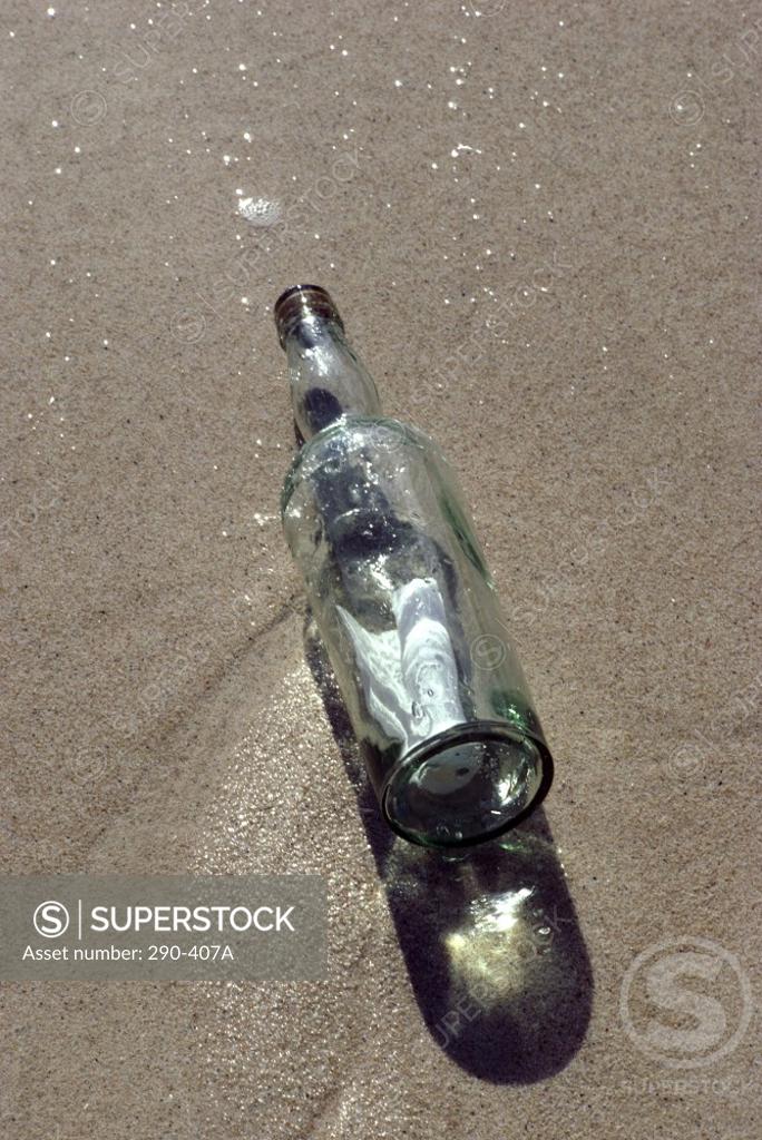 Stock Photo: 290-407A High angle view of a bottle on the beach