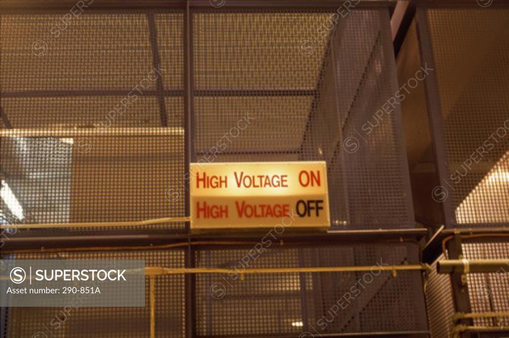 Stock Photo: 290-851A Low angle view of high voltage sign on a chain-link fence, Nuclear Research Facility, Canada