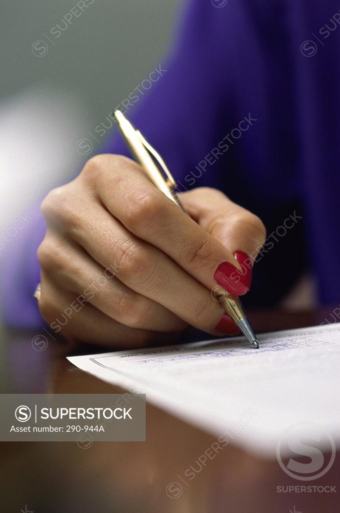 Stock Photo: 290-944A Close-up of a businesswoman writing on a sheet of paper
