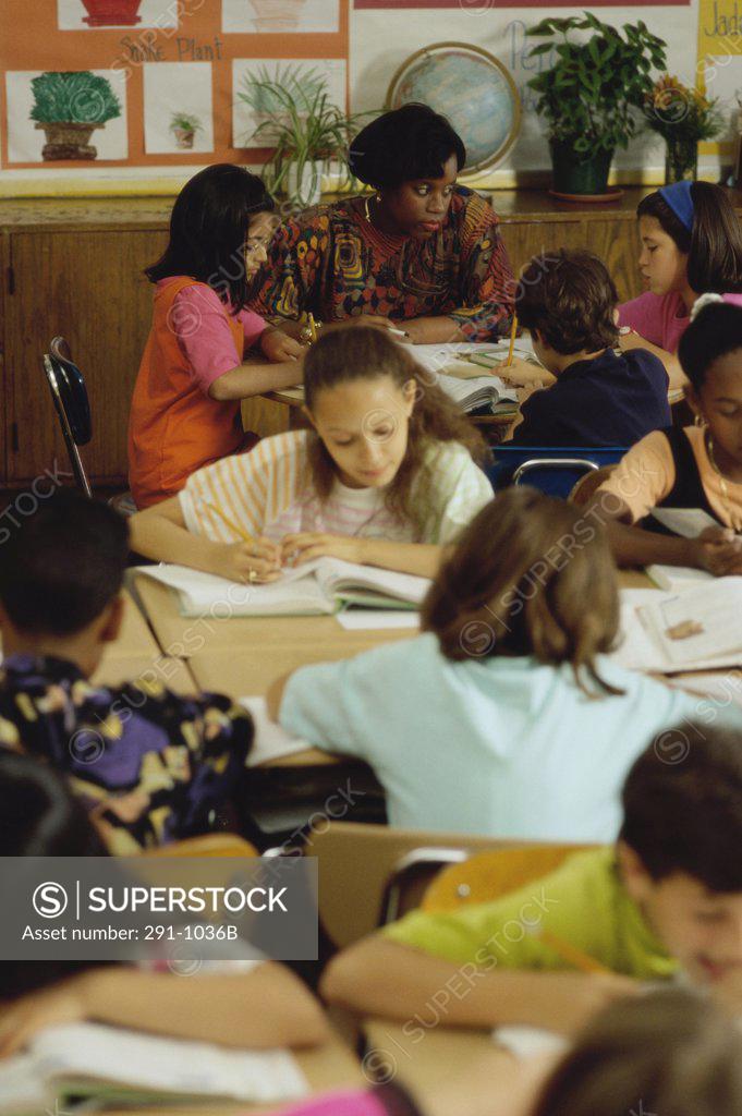 Stock Photo: 291-1036B Teacher with students in a classroom