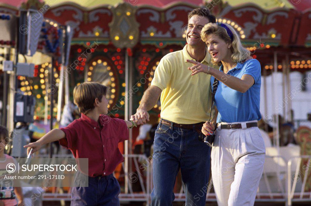 Stock Photo: 291-1718D Mid adult couple walking with their son at a carnival