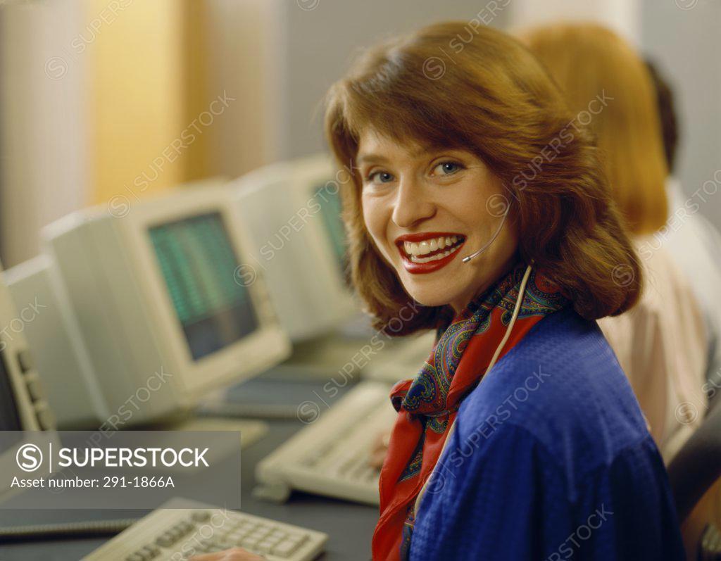 Stock Photo: 291-1866A Portrait of a businesswoman wearing a headset and smiling