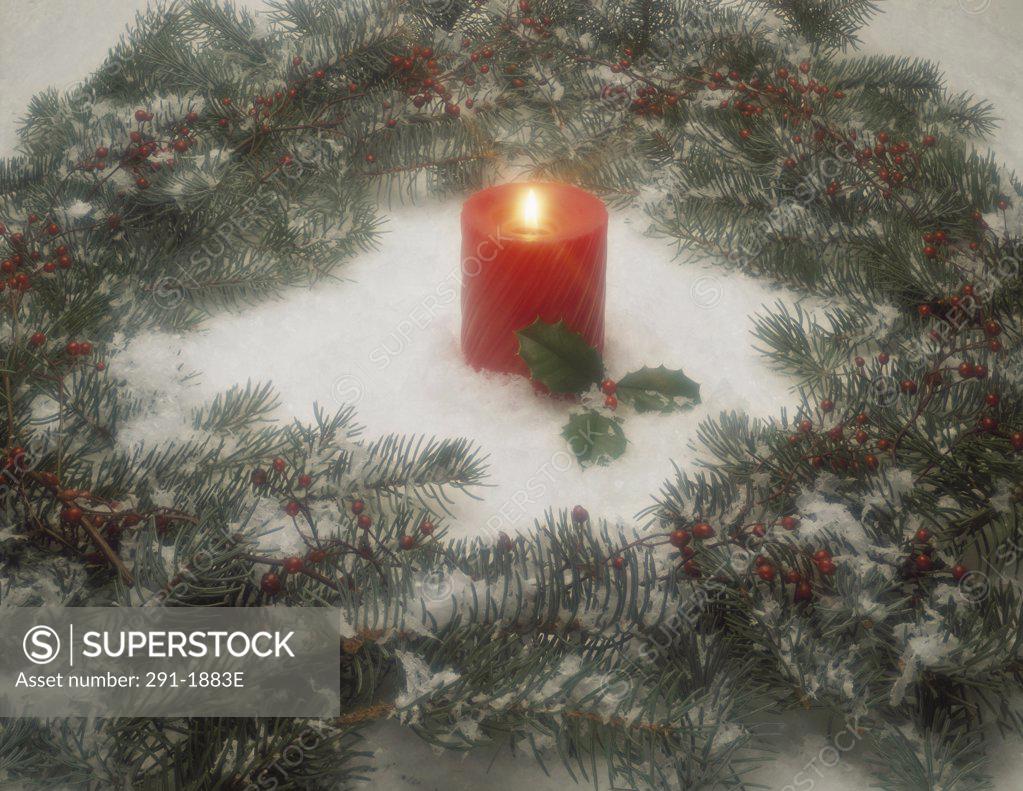 Stock Photo: 291-1883E Candle burning in the center of a Christmas wreath