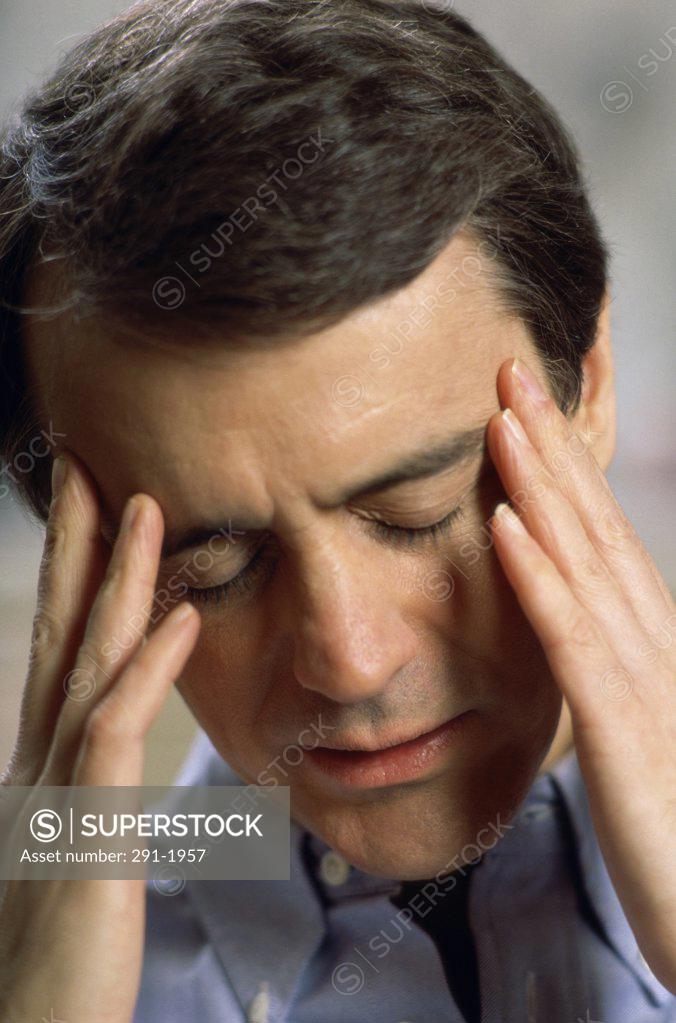 Stock Photo: 291-1957 Close-up of a mid adult man suffering from a headache