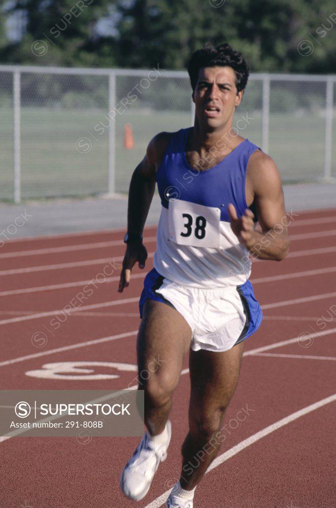 Stock Photo: 291-808B Male athlete running on a running track
