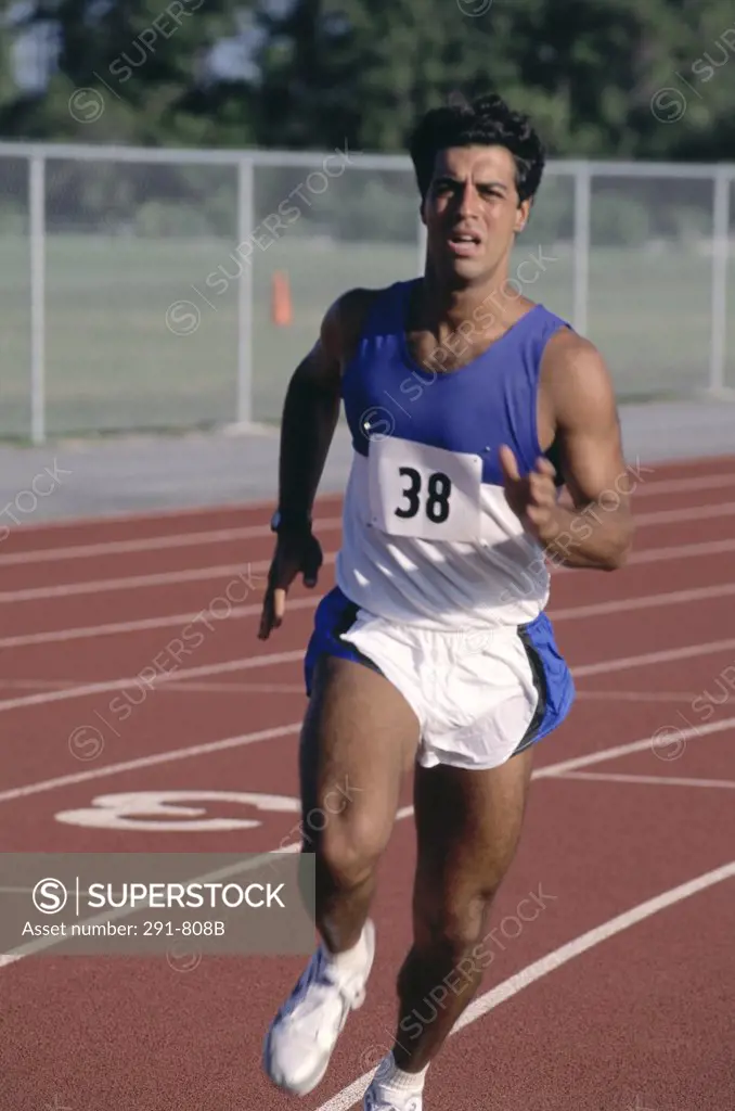 Male athlete running on a running track