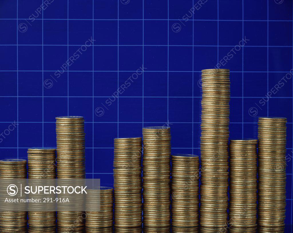 Stock Photo: 291-916A Stacks of coins arranged on a graph