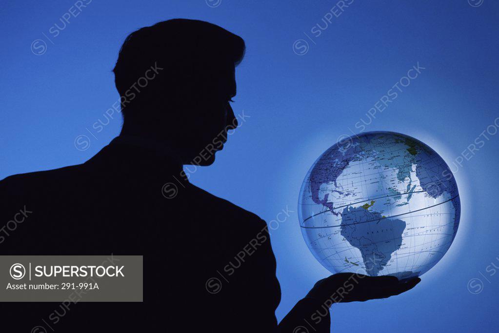 Stock Photo: 291-991A Silhouette of a businessman holding a globe